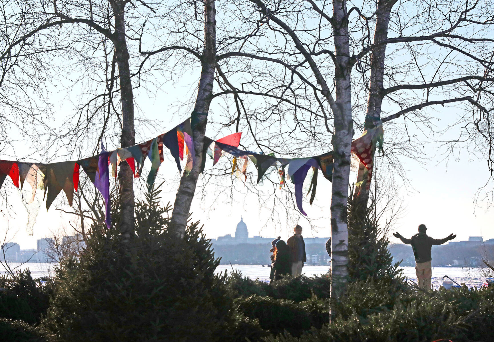 Volunteers beneath banners at "How Lovely Are Thy Branches"